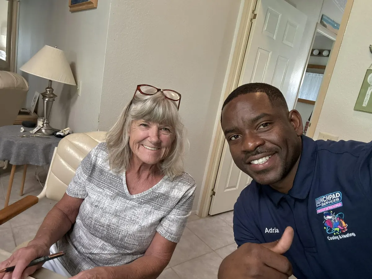 Launchpad Services technician with a smiling customer after a completed service call