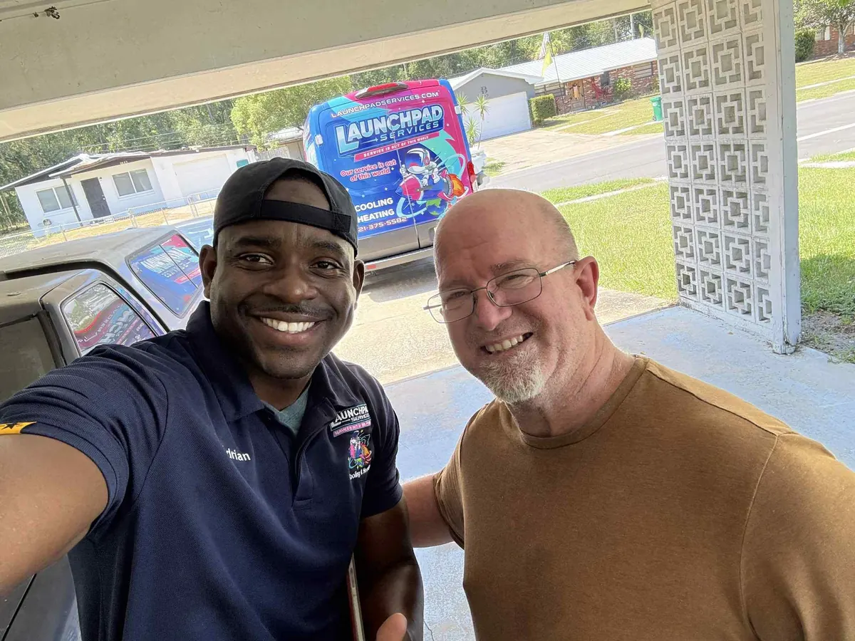 Launchpad Services technician taking a selfie with a happy Brevard County customer