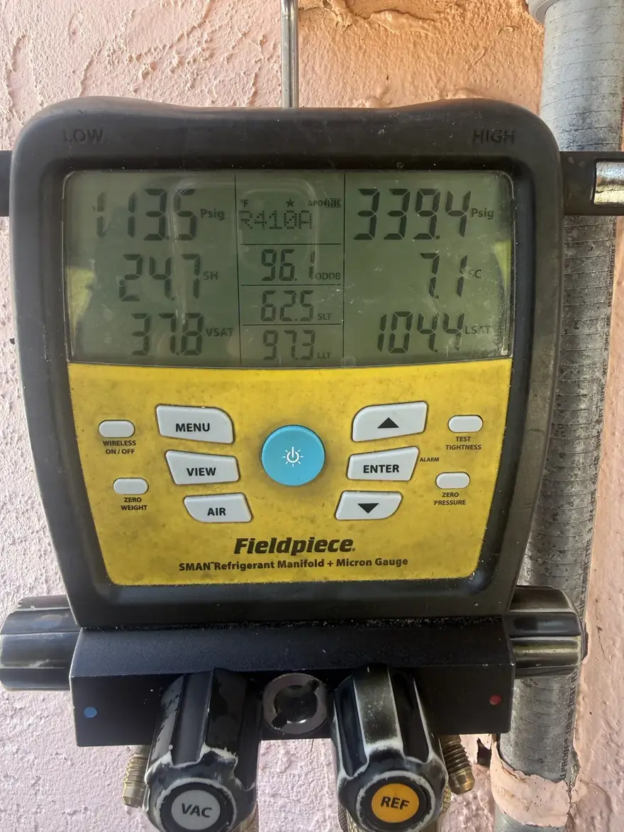 Digital manifold showing superheat and subcooling readings while checking refrigerant charge